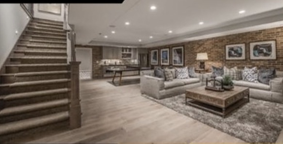 Finished basement living area with staircase